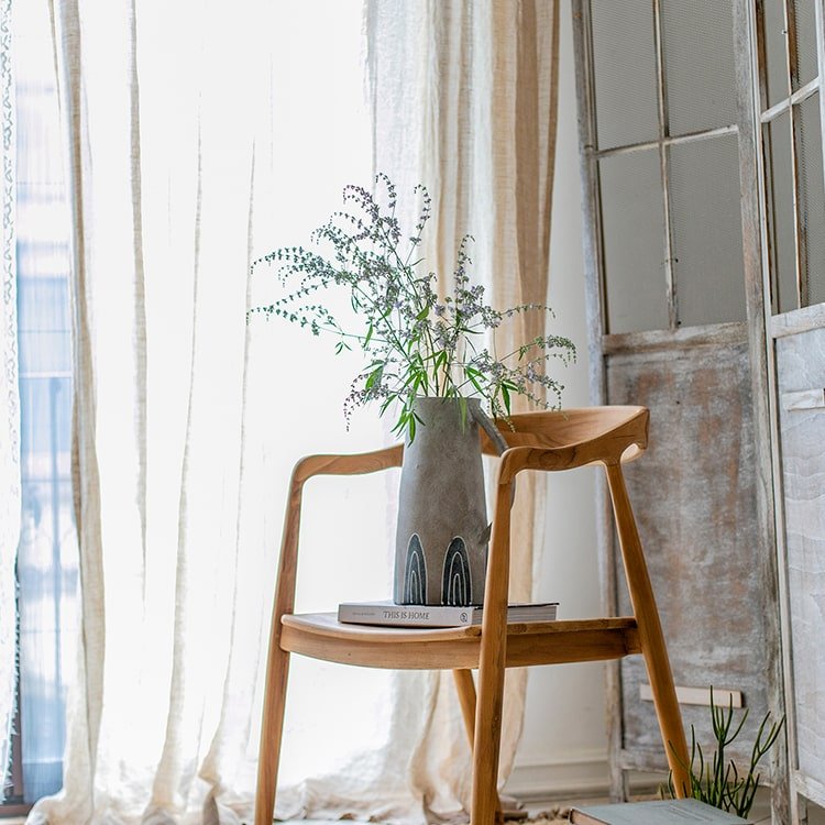 One blue handpainted terracotta vase by RusticReach on a wooden chair with greenery on Tampa Home & Garden Store