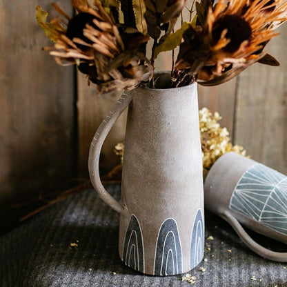 Blue handpainted terracotta vase jar with curved handle and motifs holding dried flowers on Tampa Home & Garden Store