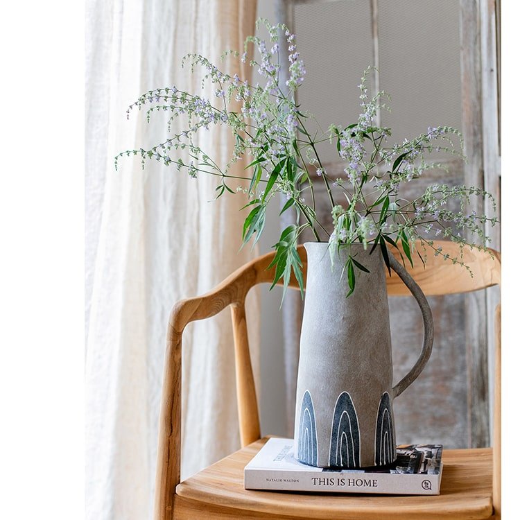 Blue handpainted terracotta vase jar RusticReach with blue arch motifs on a chair on Tampa Home & Garden Store