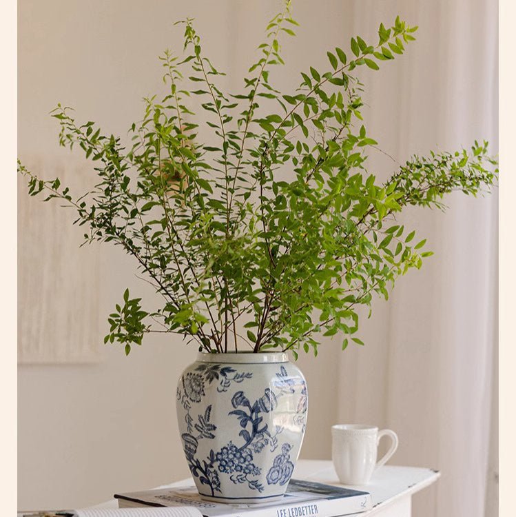 Blue and white porcelain vase with floral motif holding green branches RusticReach vase on Tampa Home & Garden Store