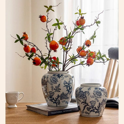 Two blue and white porcelain floral vases by RusticReach with orange fruit branches on Tampa Home & Garden Store