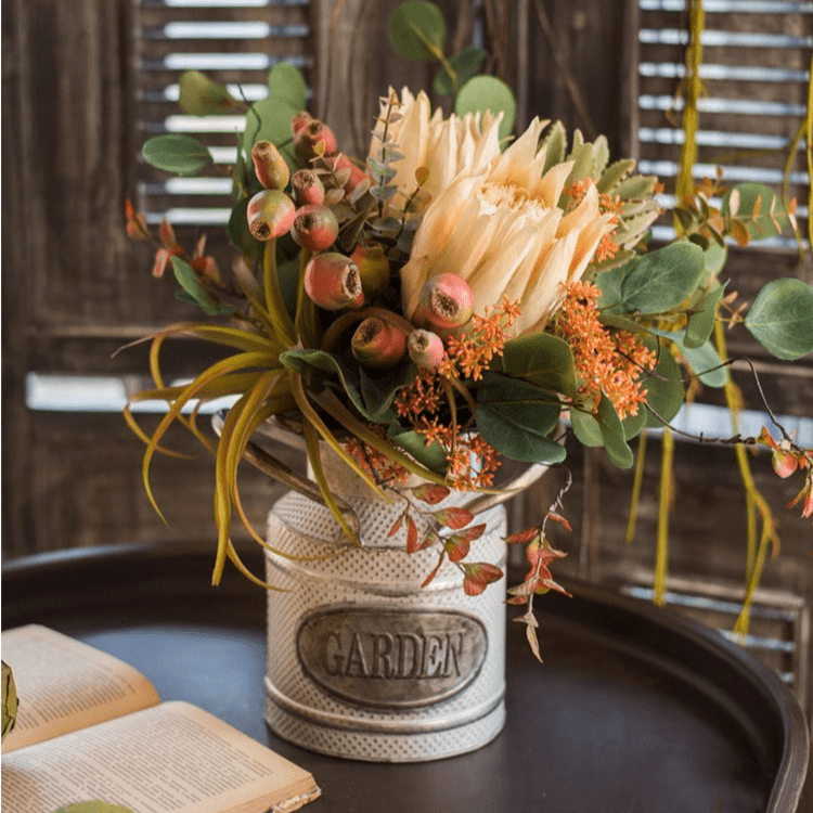 Mountian Oriole King Protea bouquet by RusticReach in a perforated metal vase with eucalyptus on Tampa Home & Garden Store
