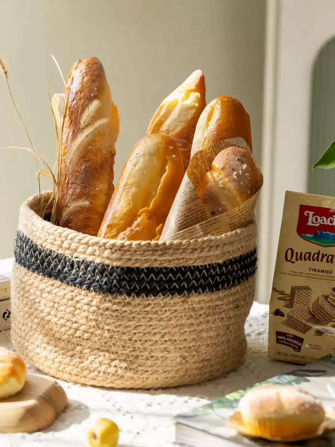 Artificial Bread & Pastry Display Props in a jute basket with black stripe and baguettes on Tampa Home & Garden Store