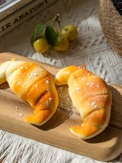 Artificial Bread & Pastry Display Props RusticReach; two golden croissant buns on a wooden board on Tampa Home & Garden Store