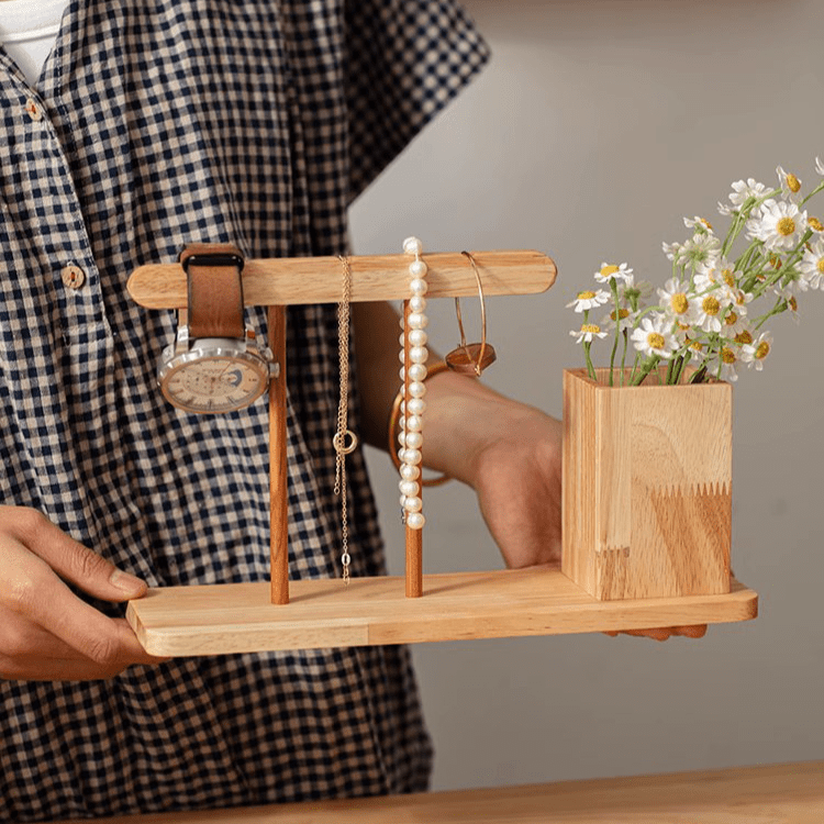 Wooden desktop calendar with pen holder in natural wood; watch, pearl necklace, and daisy vase on Tampa Home & Garden Store