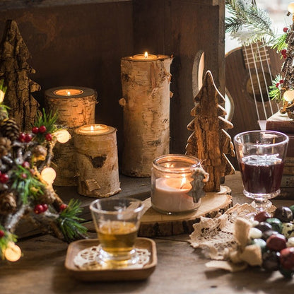 Birch wood candle holders in varied sizes with lit tea lights and rustic bark texture on Tampa Home & Garden Store