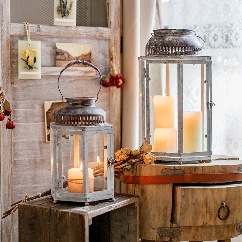 Glass metal lantern candle holder pair with glass panels and warm candles in rustic gray frames on Tampa Home & Garden Store