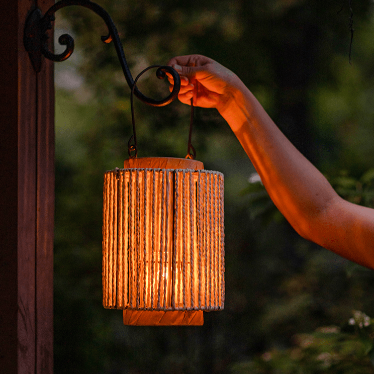 Portable rope-paper lantern candle holder with warm amber glow and hanging handles on Tampa Home & Garden Store