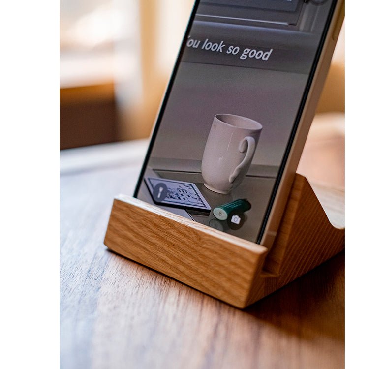 Solid Wood Cellphone Stand by RusticReach with natural oak finish holding a smartphone on a desk on Tampa Home & Garden Store