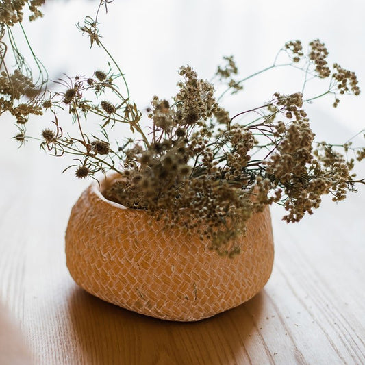 Cement weaving-pattern planter in warm tan with dried florals on Tampa Home & Garden Store