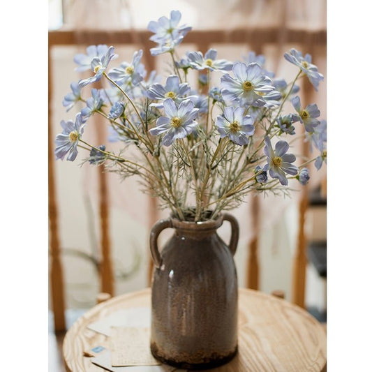 Faux Silk Cosmos Stem in Blue 24 in Tall by RusticReach in a brown glazed ceramic vase on Tampa Home & Garden Store