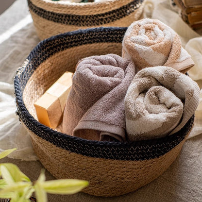 Cotton Blend Woven Storage Basket by RusticReach with three rolled beige and taupe towels on Tampa Home & Garden Store