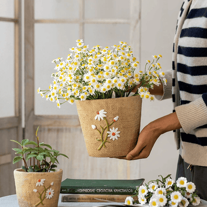 Daisy garden planter in a woven jute pot with embroidered daisies, held by a person on Tampa Home & Garden Store