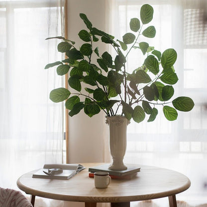 Artificial Large Dans Leaf Stem Plant by RusticReach in a white ceramic vase on a round table on Tampa Home & Garden Store