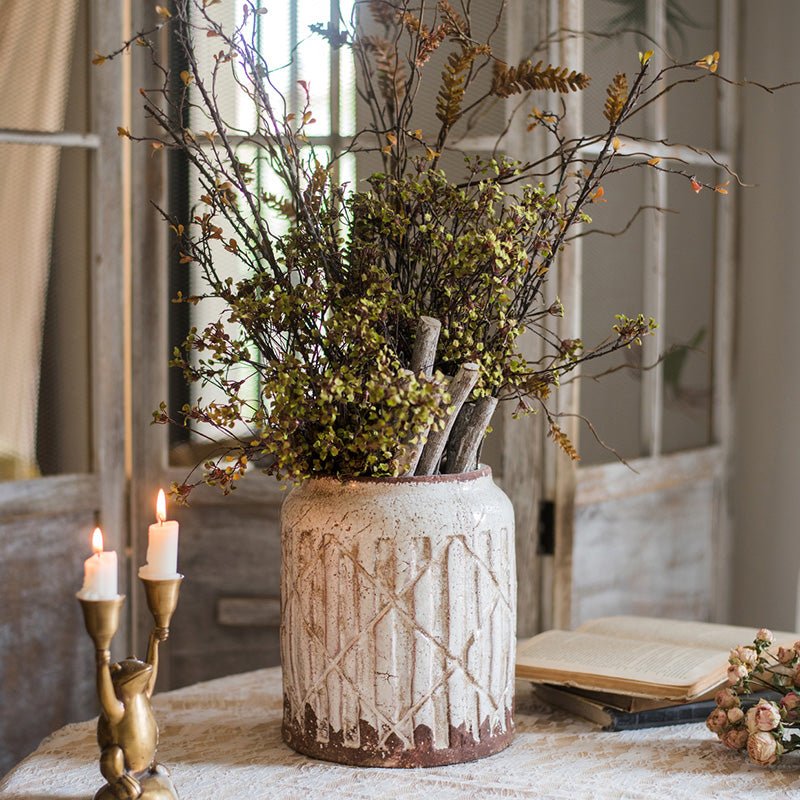 Distressed white ceramic flower jar vase with carved pattern, filled with dried branches on Tampa Home & Garden Store