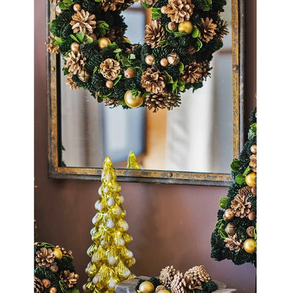 Antique Style Dark Iron Mirror framed by wreaths with gold ornaments and a Christmas tree on Tampa Home & Garden Store