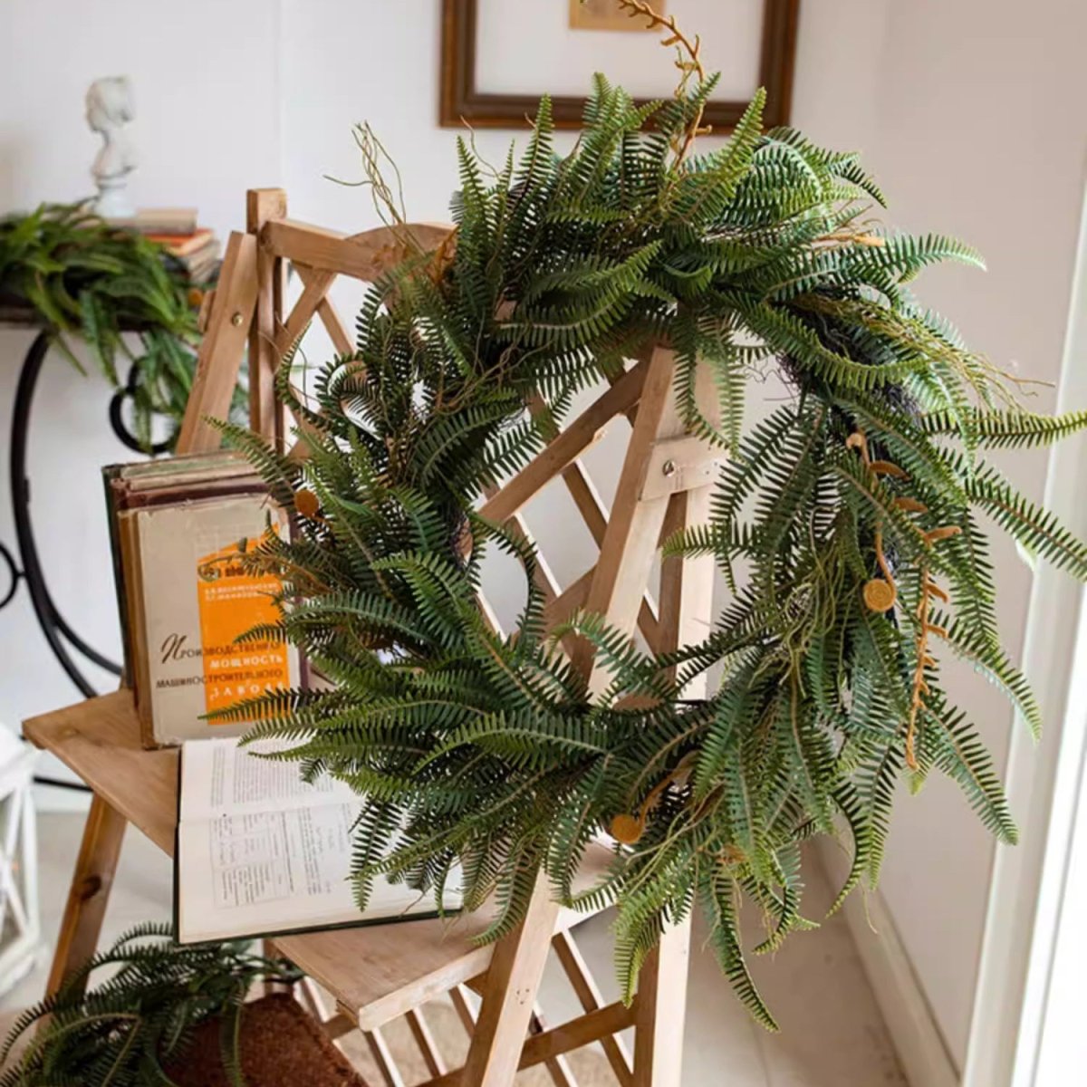 Evergreen fern garland and wreath by RusticReach, lush green faux ferns on a wooden ladder on Tampa Home & Garden Store