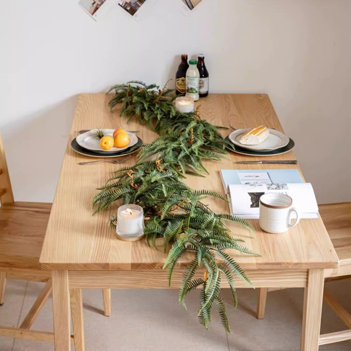 Evergreen Fern Garland and Wreath by RusticReach drapes a wooden dining table with lush greenery on Tampa Home & Garden Store