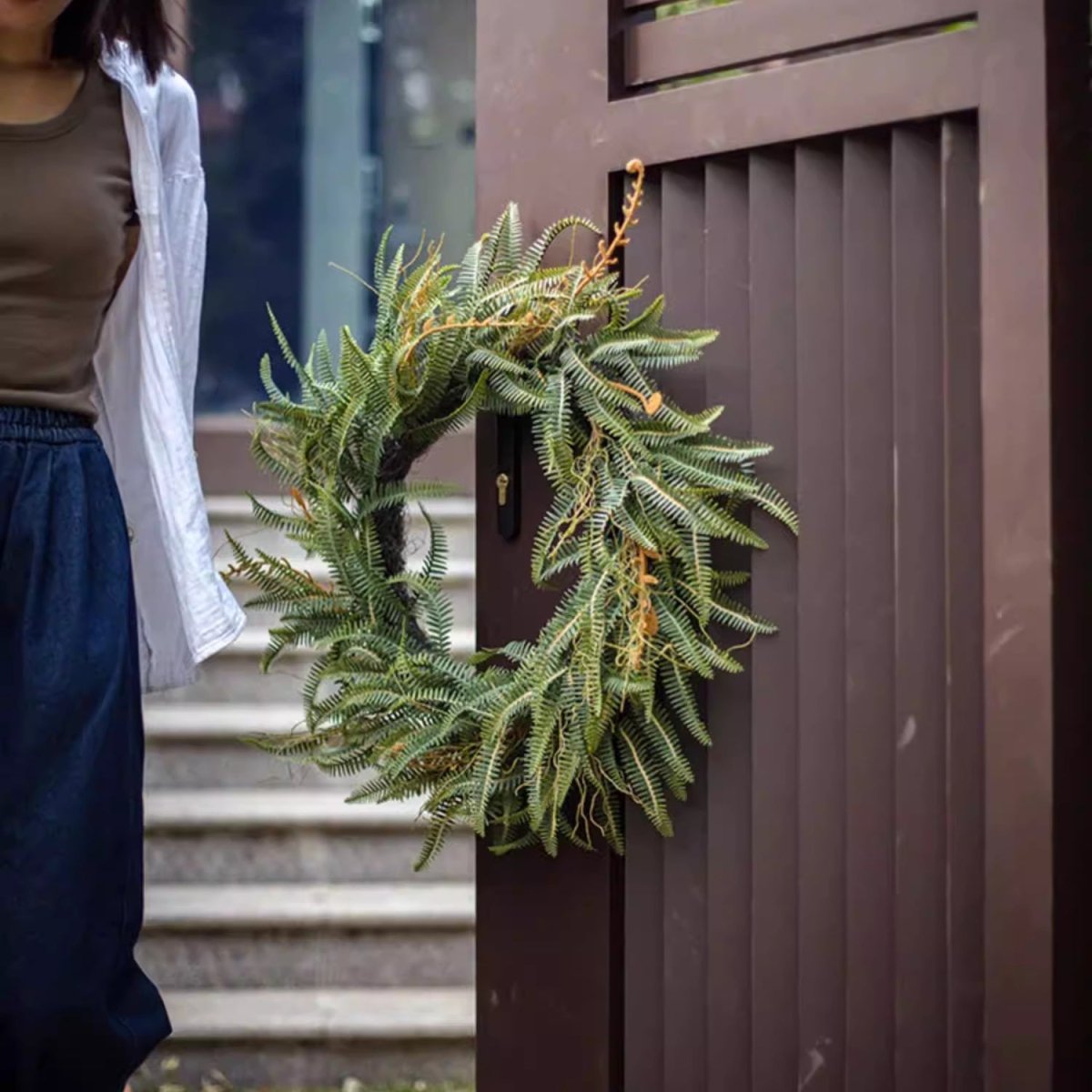 Evergreen Fern Garland and Wreath, rustic green foliage on a dark brown gate on Tampa Home & Garden Store