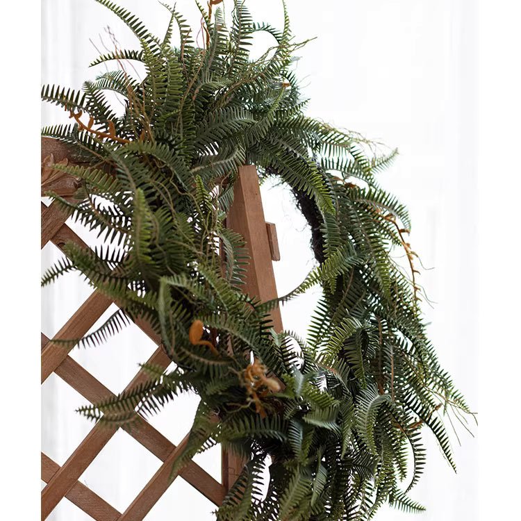 Evergreen Fern Garland and Wreath by RusticReach, lush green ferns draped over a wooden lattice on Tampa Home & Garden Store