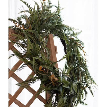 Evergreen Fern Garland and Wreath by RusticReach, lush green ferns draped over a wooden lattice on Tampa Home & Garden Store