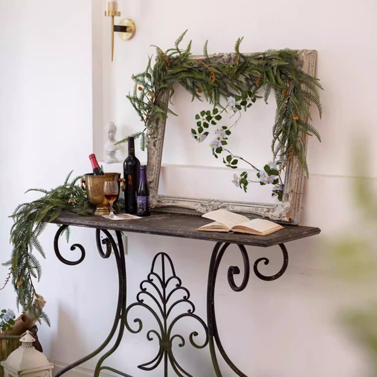 Evergreen Fern Garland and Wreath by RusticReach drapes over vintage frame on a dark wood table on Tampa Home & Garden Store