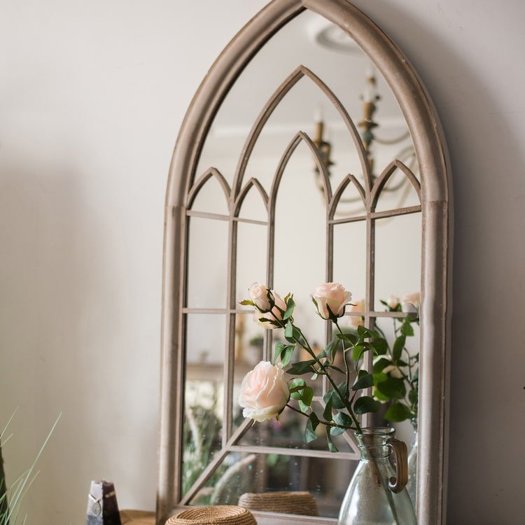 Rustic French Art Mirror with a cathedral arch frame and pale pink roses in a metal pitcher on Tampa Home & Garden Store