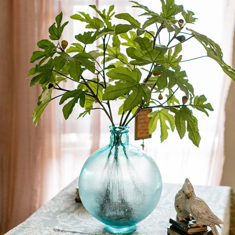 Faux Fig Leaf Stem by RusticReach in a teal glass vase with green leaves on Tampa Home & Garden Store