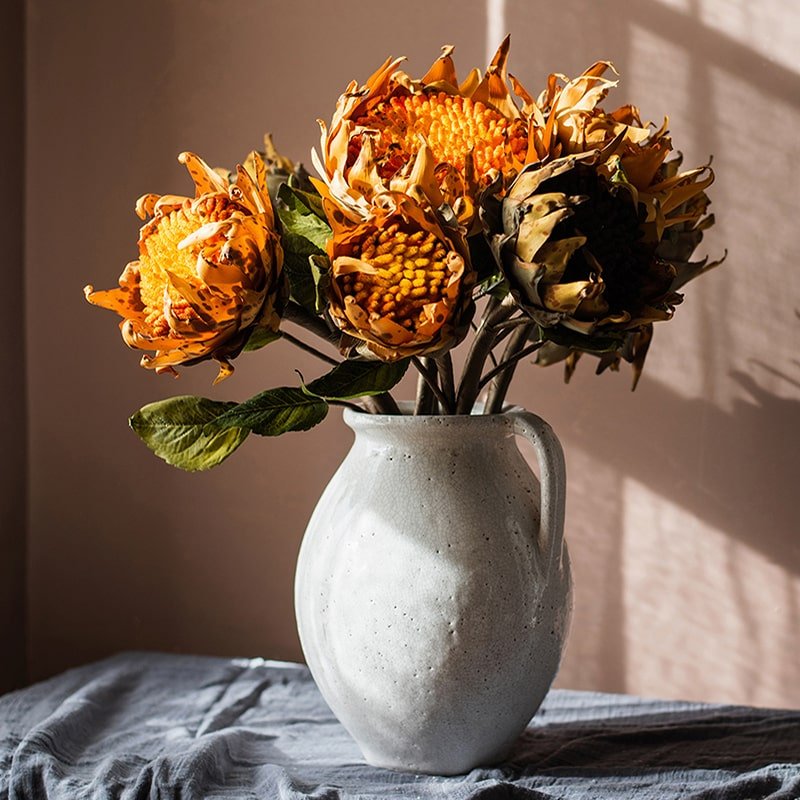 Artificial Flannel Sunflower Stems trio in a white ceramic pitcher with orange blooms on Tampa Home & Garden Store
