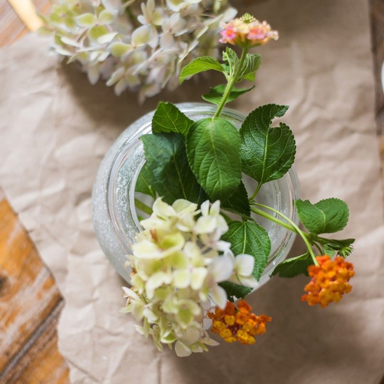 Hand Blown Foggy Glass Vase with green leaves, white hydrangea blooms and orange lantana on Tampa Home & Garden Store