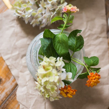 Hand Blown Foggy Glass Vase with green leaves, white hydrangea blooms and orange lantana on Tampa Home & Garden Store