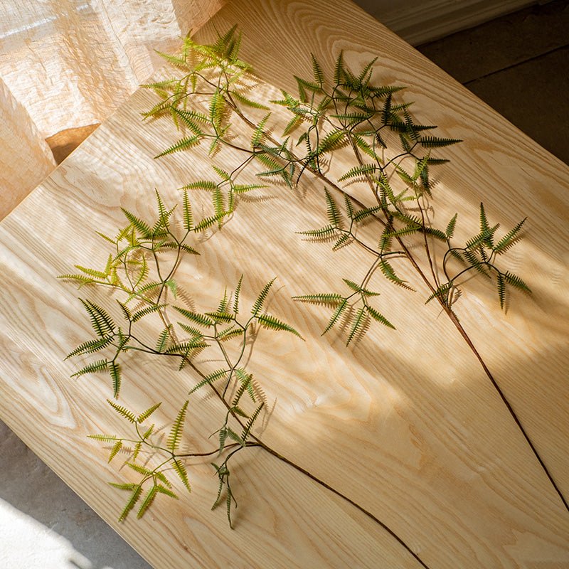 Artificial Forked Fern Stems with green fronds on light wood surface on Tampa Home & Garden Store