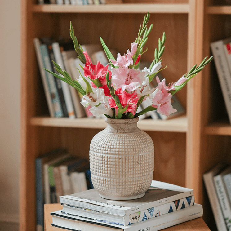 Faux Silk Gladiolus Stem RusticReach, pink and white blooms in beige vase on books on Tampa Home & Garden Store