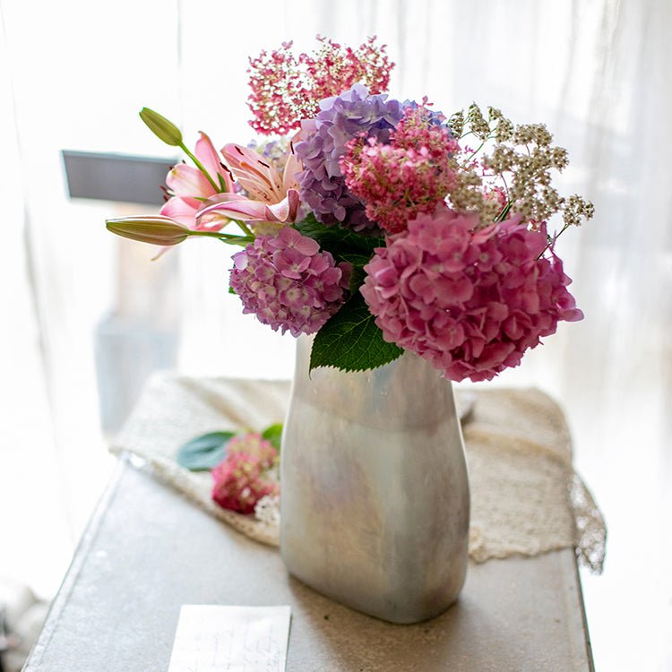 Gradient Color Art Glass Vase with iridescent finish and pink hydrangea bouquet on Tampa Home & Garden Store