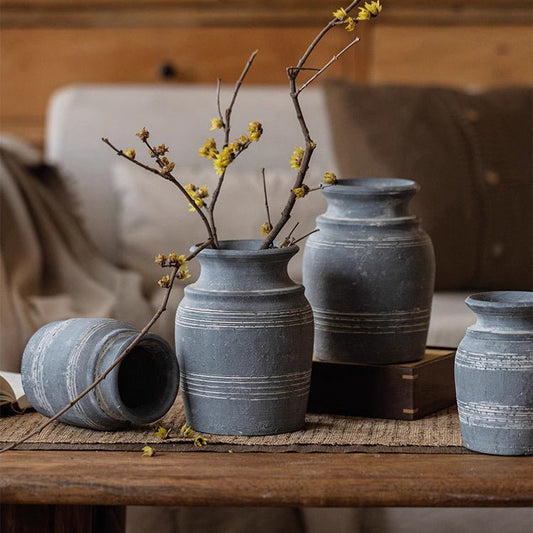 Handmade gray clay pottery vase set by RusticReach; four blue-gray vases with bands on a table on Tampa Home & Garden Store