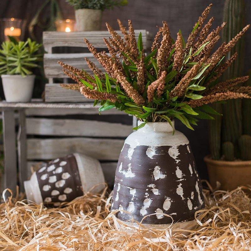 Handcrafted ceramic vase brown with white speckle glaze filled with green foliage on Tampa Home & Garden Store