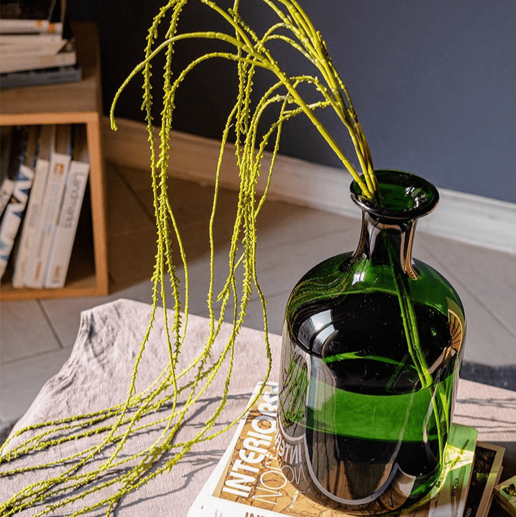 Artificial Vine Hanging Thin Succulent Stem lime green cascading from a green glass bottle vase on Tampa Home & Garden Store
