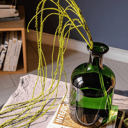 Artificial Vine Hanging Thin Succulent Stem lime green cascading from a green glass bottle vase on Tampa Home & Garden Store