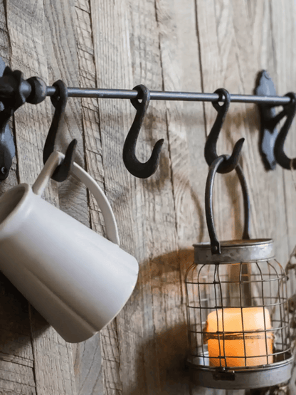 Farmhouse Iron Hook Rail with black iron hooks on rustic wood backdrop on Tampa Home & Garden Store