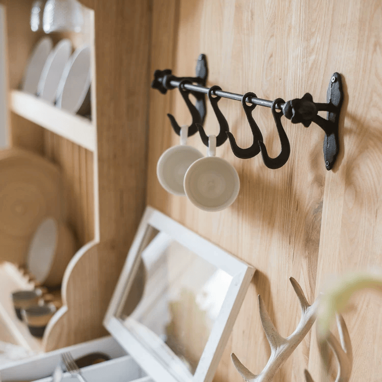 Farmhouse iron hook rail with five black hooks mounted on wood wall RusticReach on Tampa Home & Garden Store