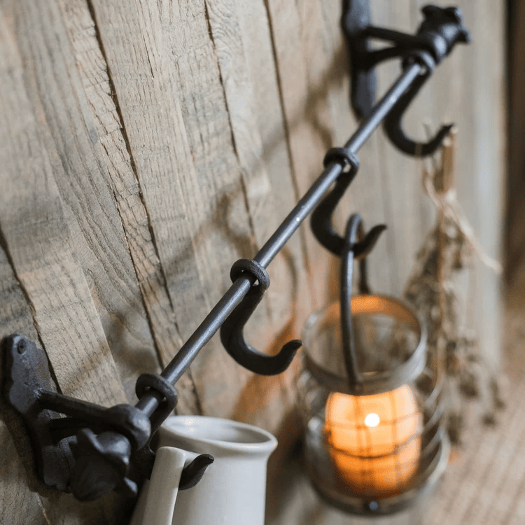 Farmhouse Iron Hook Rail by RusticReach with black iron hooks mounted on rustic wood wall on Tampa Home & Garden Store