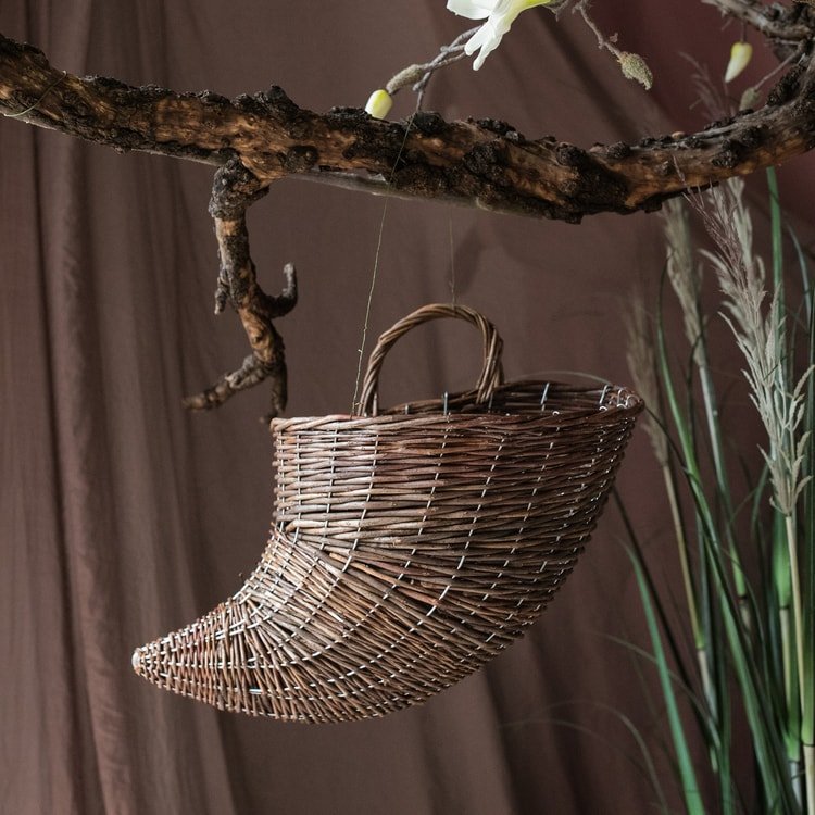 Horn shape willow hanging basket planter by RusticReach brown woven basket suspended from branch on Tampa Home & Garden Store