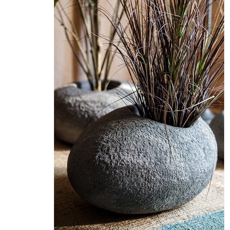 Japanese Zen Style Gray Stone Flowerpot with tall grasses in a textured round rock pot on Tampa Home & Garden Store