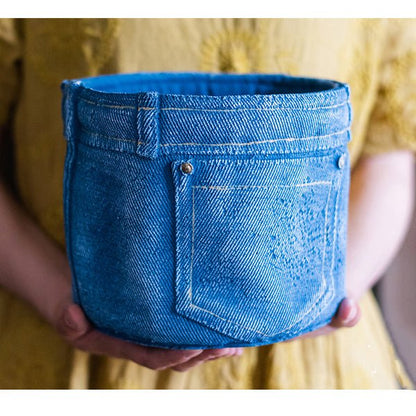 Blue denim jeans planter pot with back pocket detail held by hands on Tampa Home & Garden Store
