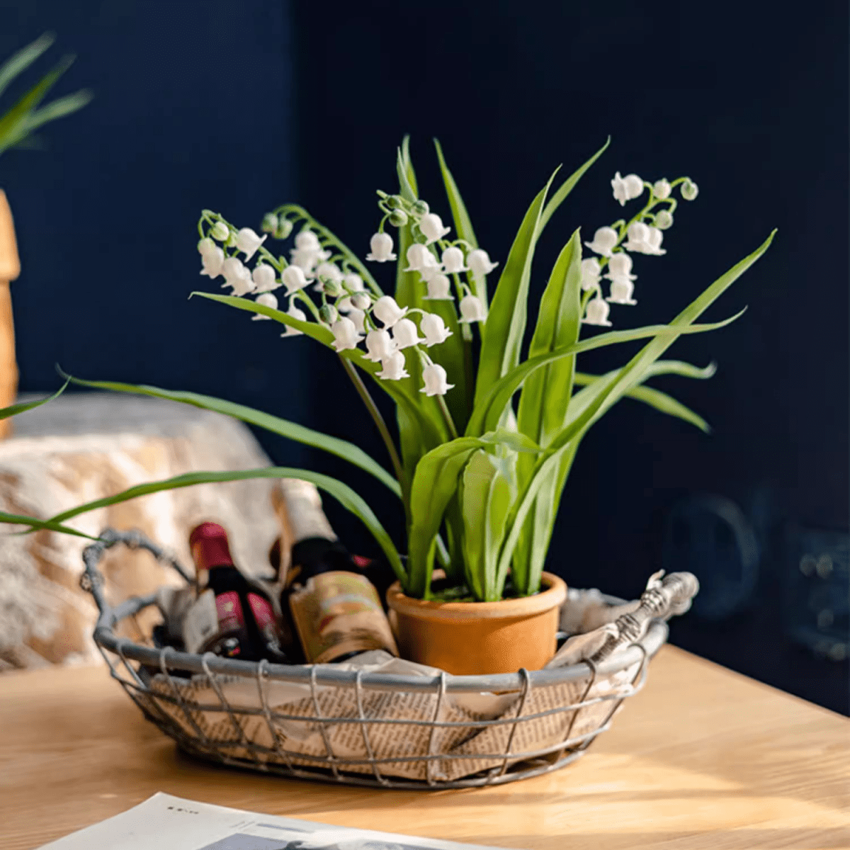 Faux Lily of the Valley in brown pot with green leaves on a wire basket on Tampa Home & Garden Store