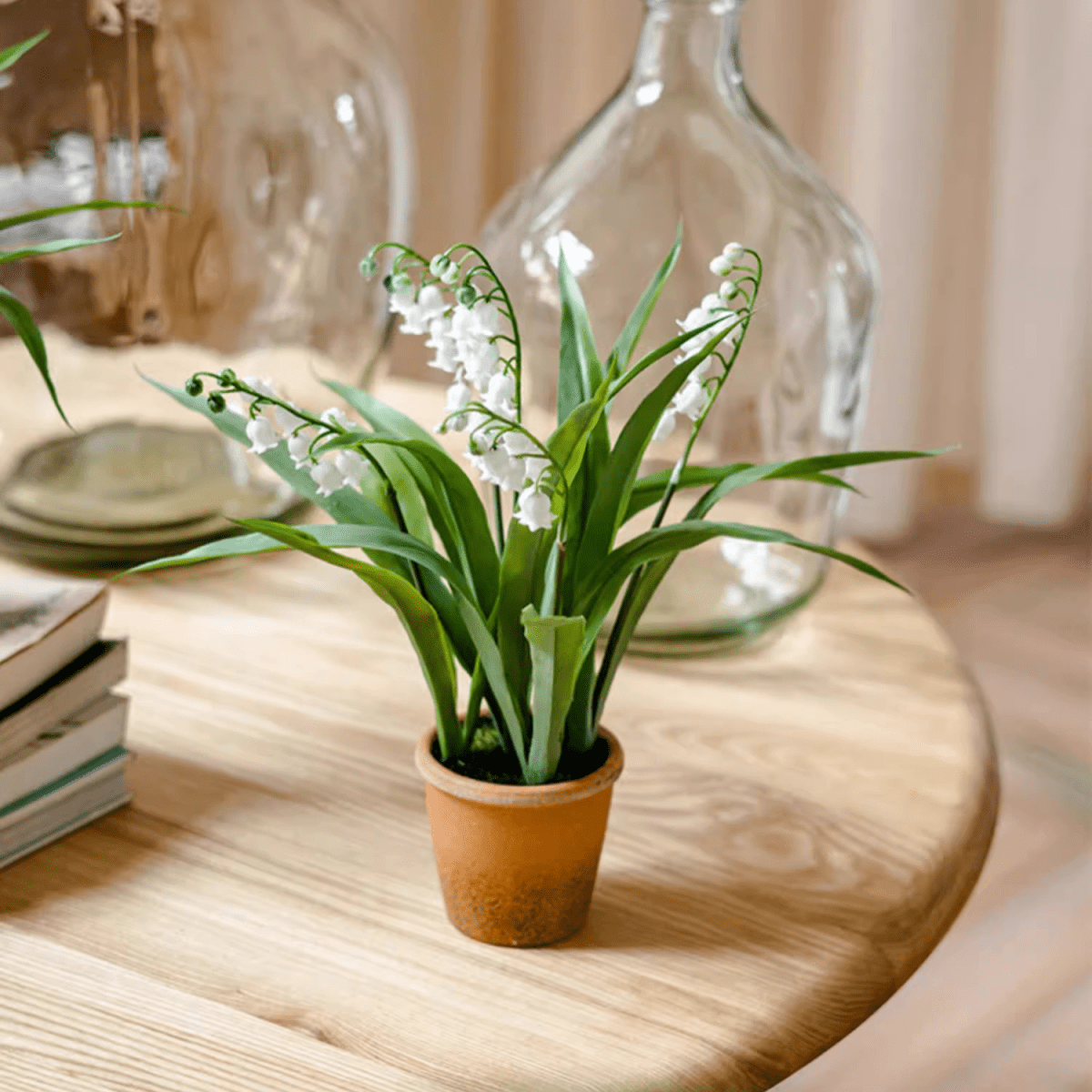 Faux Lily of the Valley plant in a terracotta pot with green leaves and white bell flowers on Tampa Home & Garden Store