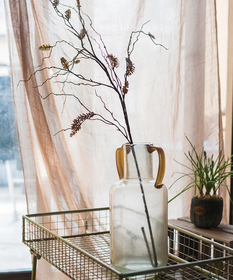 Ling Yu grass stem RusticReach in a clear glass bottle with amber handles, 47 inches tall on Tampa Home & Garden Store