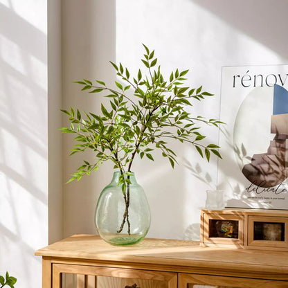 Green Nandina Leaf Stem artificial flora in a round glass vase on a wooden table on Tampa Home & Garden Store