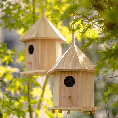 Natural solid wood birdhouse pair with pointed roofs, hanging on twine for outdoor garden decor on Tampa Home & Garden Store