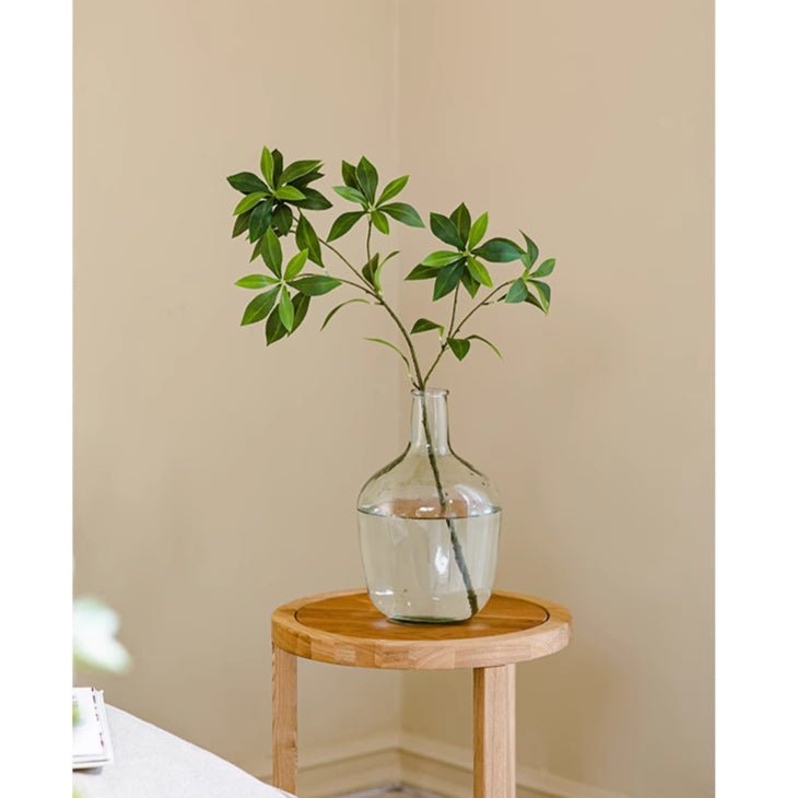 Faux Pieris Branch Stem RusticReach; artificial plant in glass vase on table with green leaves on Tampa Home & Garden Store
